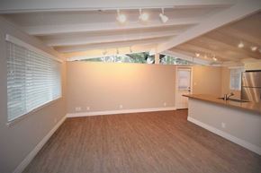 Lafayette apartment for rent - an empty living room with a kitchen and a large window