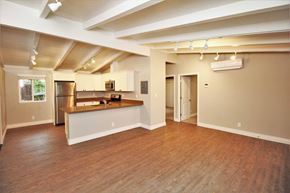 Lafayette apartment for rent - an empty living room with a kitchen and a hard wood floor