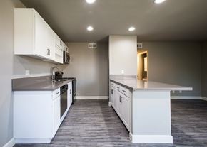 Tucson apartment for rent - A kitchen with white cabinets and a grey counter top.