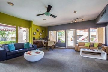 Tucson apartment for rent - A living room with a blue couch and a white coffee table.