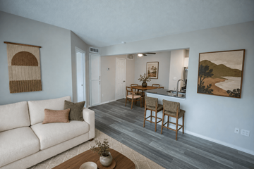 Springdale apartment for rent - A living room with a couch, chairs, and a painting on the wall.