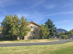 Bozeman apartment for rent - A building with a grassy area in front of it.
