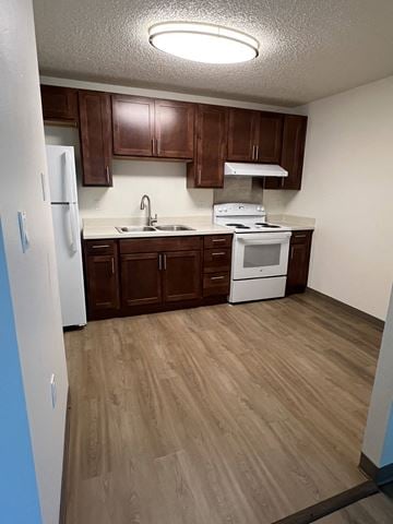 Livingston apartment for rent - A kitchen with brown cabinets and a white fridge.