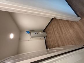 Bozeman apartment for rent - A white air conditioning unit is installed on a wooden wall.