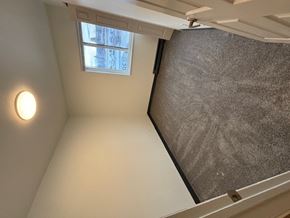 Bozeman apartment for rent - A small room with a window and a light on the wall.