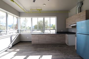 Livingston apartment for rent - A kitchen with a blue refrigerator and wooden cabinets.