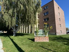 Livingston apartment for rent - the exterior of a building with a sign in the grass