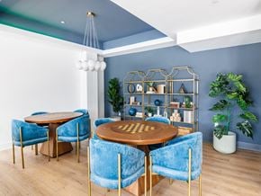Plainfield apartment for rent - a dining room with blue chairs and a table with a chess board