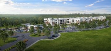Manor apartment for rent - A large building complex with a parking lot in front.