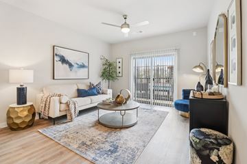 Corinth apartment for rent - A living room with a white couch, a coffee table, and a painting on the wall.