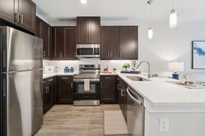 Corinth apartment for rent - A modern kitchen with dark brown cabinets and stainless steel appliances.