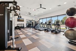 Corinth apartment for rent - A gym with a variety of equipment including a weight machine, a treadmill, and a rowing machine.