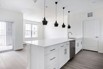 Burleson apartment for rent - A kitchen with white cabinets and a white counter top.