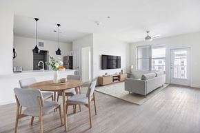 Burleson apartment for rent - A modern dining room with a round table and grey chairs at 901 Rendon, Burleson, TX 76028