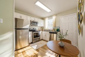 Richmond apartment for rent - A kitchen with a table and chairs in the middle of the room.