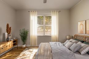 Richmond apartment for rent - A bedroom with a large bed and a potted plant.