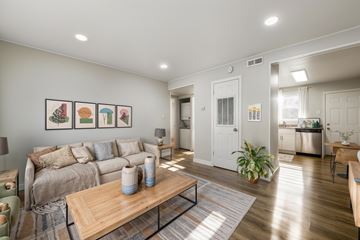 Richmond apartment for rent - A living room with a couch, a coffee table, and a painting on the wall.