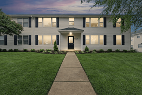 Richmond apartment for rent - A building with a black door and windows with shutters.