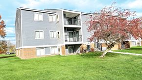 Kentwood apartment for rent - the outlook of an apartment building with a flowering tree