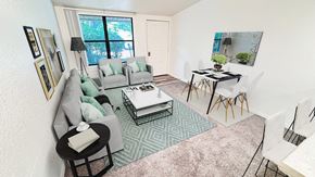 Ann Arbor apartment for rent - A living room with a grey couch, a black coffee table, and a green rug.