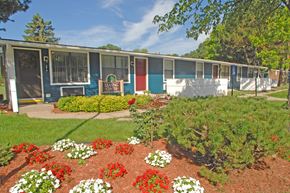 Lansing apartment for rent - A garden in front of a row of trailer homes.