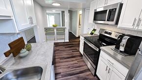 Davison apartment for rent - a kitchen with stainless steel appliances and white cabinets