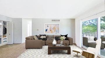 Grand Blanc apartment for rent - A living room with a brown couch and a coffee table.