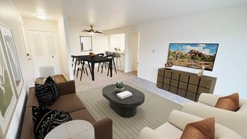 Flint apartment for rent - A living room with a brown couch and a painting of a house on the wall.