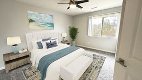 Howell apartment for rent - A bedroom with a large bed and a ceiling fan.