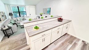 Ann Arbor apartment for rent - A kitchen with a large island and a dining table with chairs.