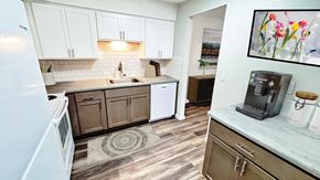Kentwood apartment for rent - A kitchen with a white refrigerator and wooden cabinets.