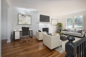 Dobbs Ferry apartment for rent - A modern living room with a white desk and a grey couch.