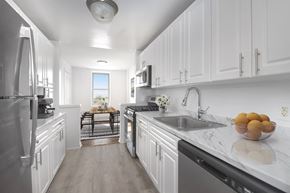 Long Beach apartment for rent - A modern kitchen with white cabinets and stainless steel appliances.