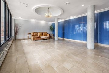 Long Beach apartment for rent - A living room with a tan couch and a chandelier.