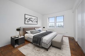 Long Beach apartment for rent - A bedroom with a bed, bench, and window.