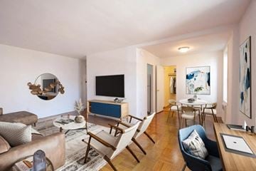 Long Beach apartment for rent - A living room with a brown leather couch and a wooden chair.