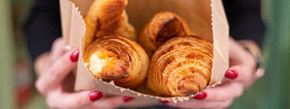 New York apartment for rent - A person holding a paper container filled with croissants.