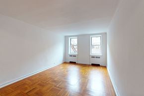 Queens apartment for rent - A room with wooden floors and two windows.