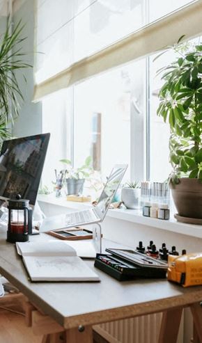 New York apartment for rent - A desk with a laptop, a plant, and a notebook.