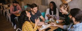 New York apartment for rent - A group of people are sitting around a table in a casual setting.