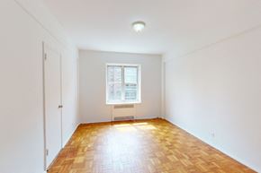 Forest Hills apartment for rent - A room with a window and a wooden floor.