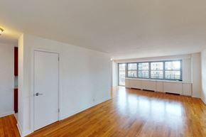 New York apartment for rent - A room with wooden floors and white walls.