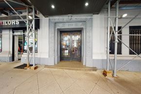 New York apartment for rent - The image shows a building entrance with a large glass door and a decorative frame above it.