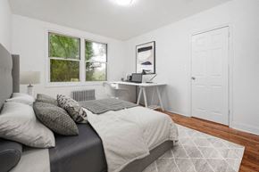 White Plains apartment for rent - A bedroom with a bed, desk, and window.