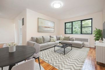 Dobbs Ferry apartment for rent - A living room with a grey couch, a coffee table, and a painting on the wall.