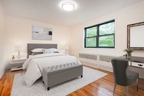 Dobbs Ferry apartment for rent - A bedroom with a large bed and a chair.