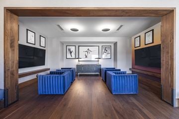 Park City apartment for rent - A living room with a blue couch and a television.