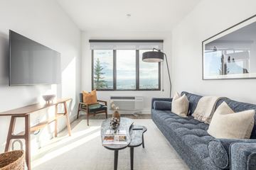 Park City apartment for rent - a living room with a blue couch and a tv