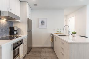 Park City apartment for rent - a kitchen with white cabinets and a counter top