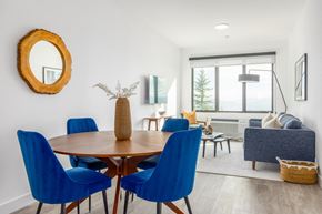 Park City apartment for rent - a dining room with blue chairs and a wooden table